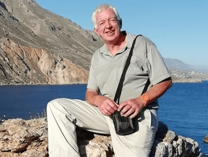 Man posing on rock near water