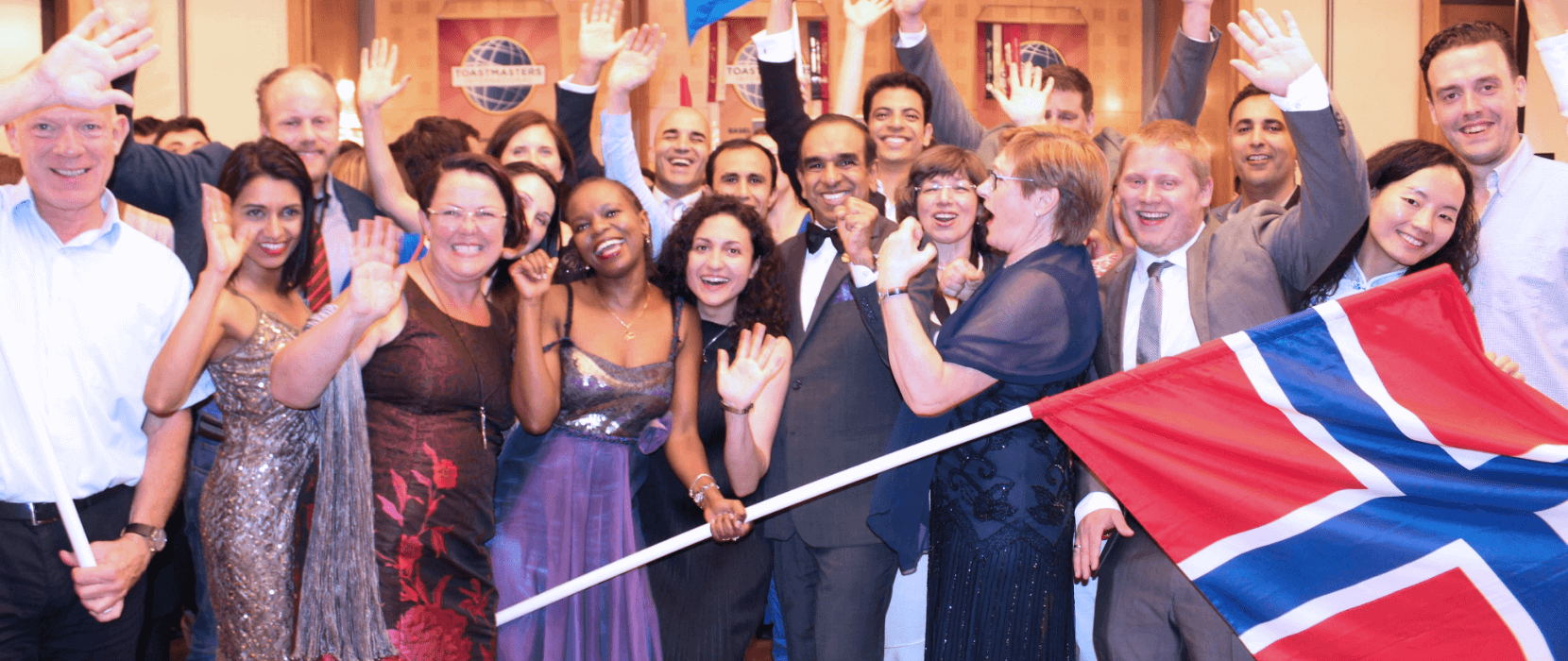 People smiling with arms in the air
