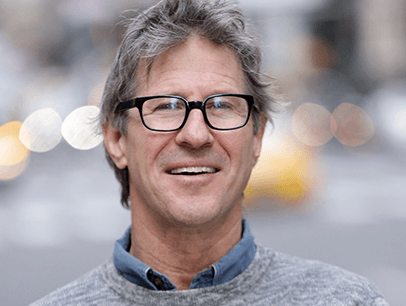 John Bowe posing in gray sweater
