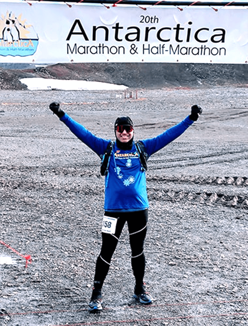 Toastmaster Satish Shenoy celebrates after completing a marathon in Antarctica.